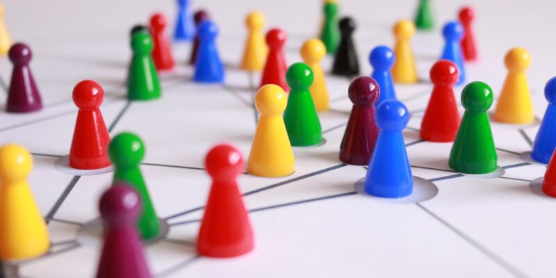 Plastic game counters representing different people laid out in a network: How do we optimise team culture?