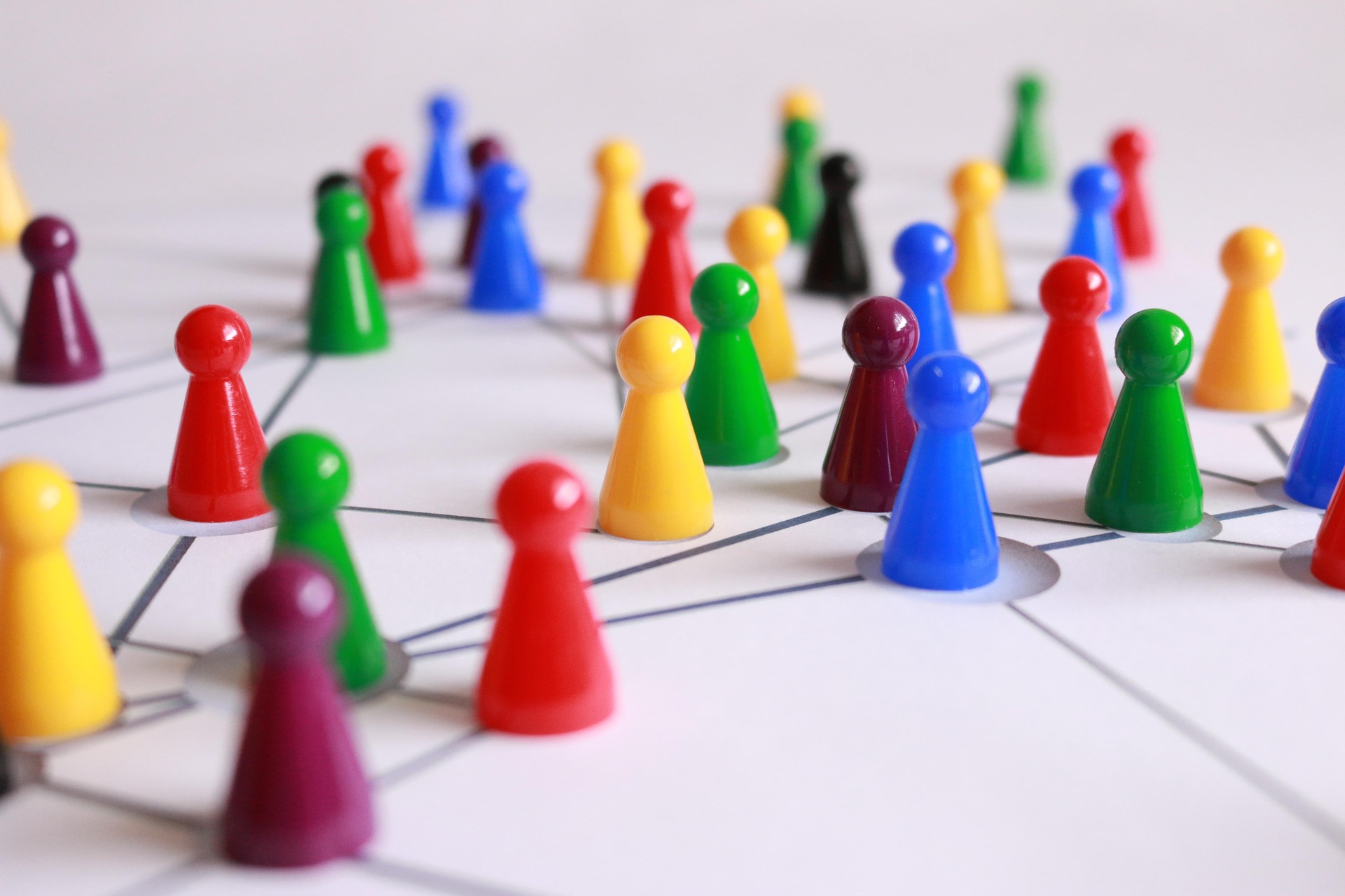 Plastic game counters representing different people laid out in a network: How do we optimise team culture?