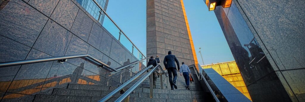 Photo of business leaders going up stairs - metaphor for going to the next level in business